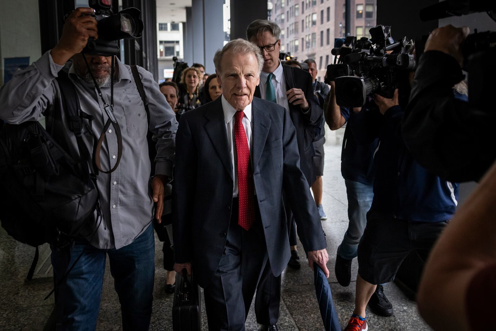 Flanked by attorneys and supporters, Illinois' former House Speaker Michael Madigan walks into the Dirksen Federal Courthouse for his sentencing hearing, Friday, June 13, 2025, in Chicago. (Ashlee Rezin/Chicago Sun-Times via AP)