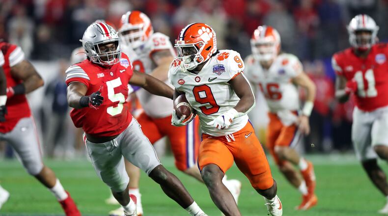 GLENDALE, ARIZONA - DECEMBER 28:  Travis Etienne #9 of the Clemson Tigers carries the ball for a 53-yard touchdown reception against the Ohio State Buckeyes in the second half during the College Football Playoff Semifinal at the PlayStation Fiesta Bowl at State Farm Stadium on December 28, 2019 in Glendale, Arizona. (Photo by Matthew Stockman/Getty Images)