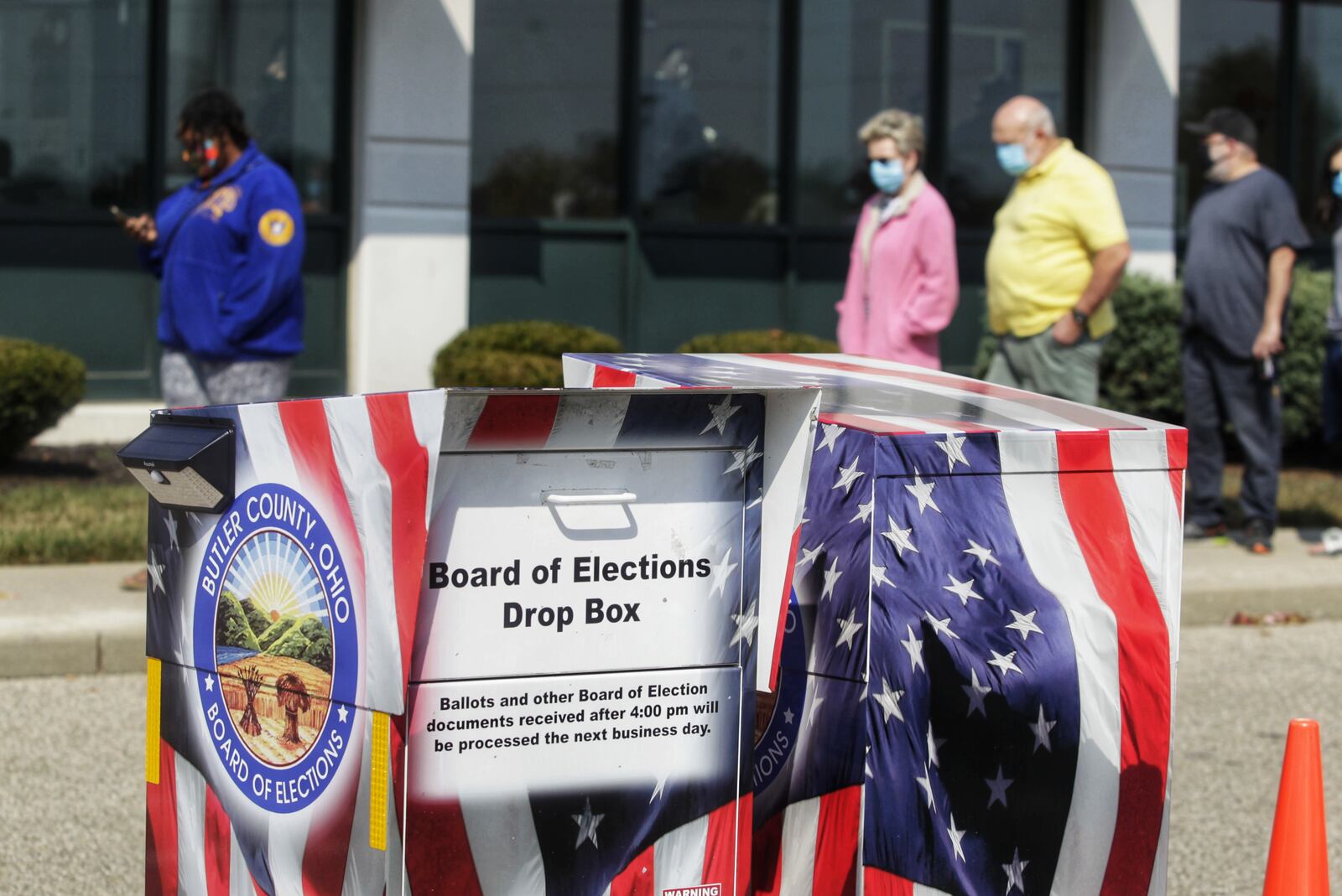 Voters line up at the Butler County Board of Elections on the first day of early voting Tuesday, October 6, 2020 in Hamilton. NICK GRAHAM / STAFF