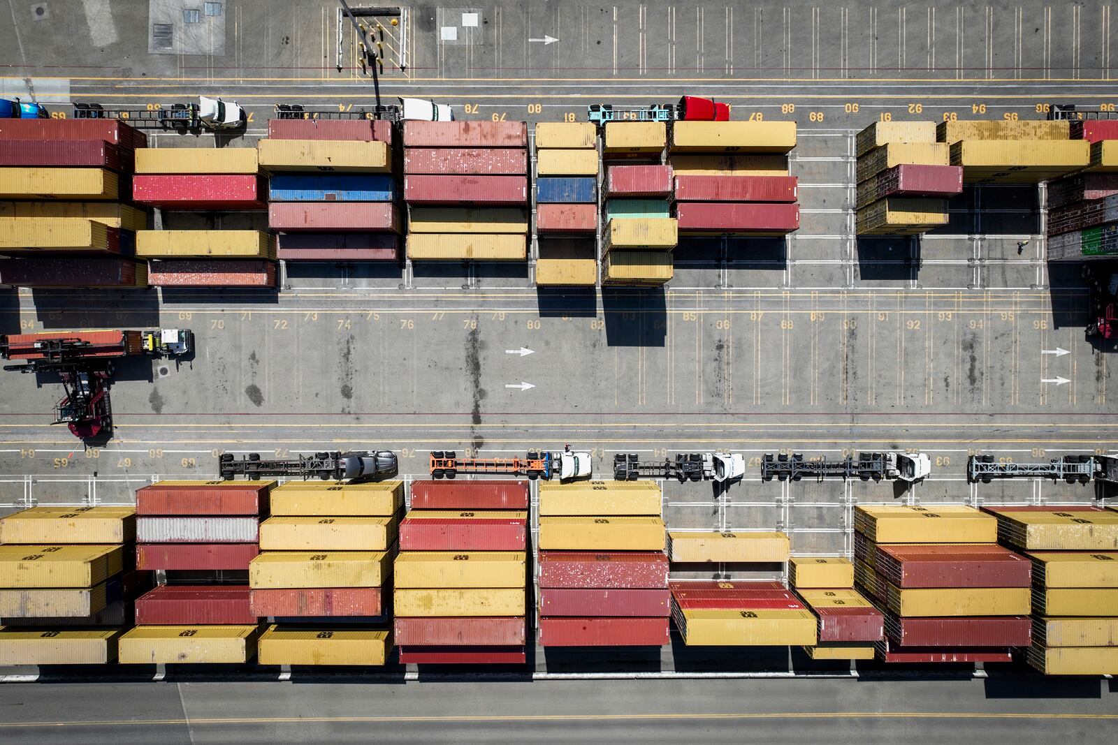 Cargo sits at The Port of Oakland as trucks are parked nearby in Oakland, Calif., Thursday, April 3, 2025. (Bronte Wittpenn/San Francisco Chronicle via AP)
