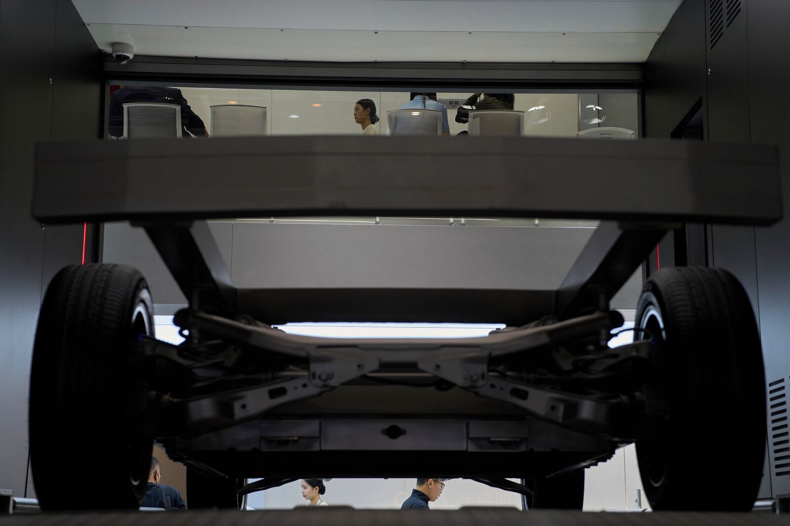 Visitors past by a demonstration of battery switching technology from Chinese battery manufacturer CATL at the Shanghai auto show on Thursday, April 24, 2025. (AP Photo/Ng Han Guan)