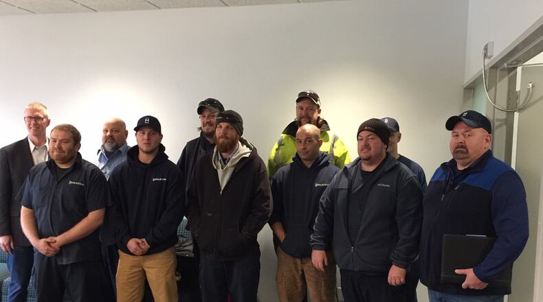 The city of Beavercreek expressed its appreciation to members of the Middletown Public Works Department with a special photograph, city proclamation and challenge coins on Monday. Middletown public works crews helped with clearing brush and other debris to clear streets after the Memorial Day tornadoes. ED RICHTER/STAFF