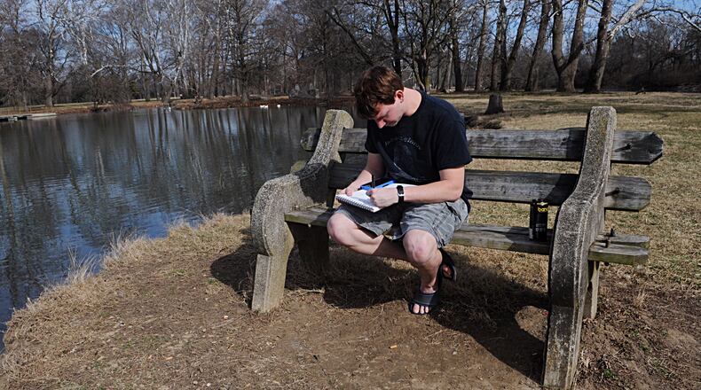 Bryan Turner, takes advantage of the nice weather Monday to come out and sit by one of the ponds at Eastwood Park. MARSHALL GORBY/STAFF