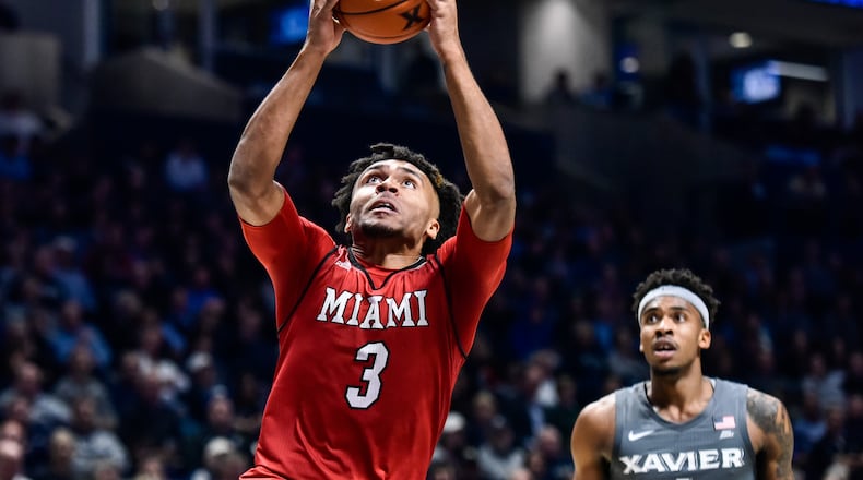 Miami’s Jalen Adaway goes up for a slam dunk during their basketball game against Xavier Wednesday, Nov. 28 at Xavier’s Cintas Center in Cincinnati. NICK GRAHAM/STAFF