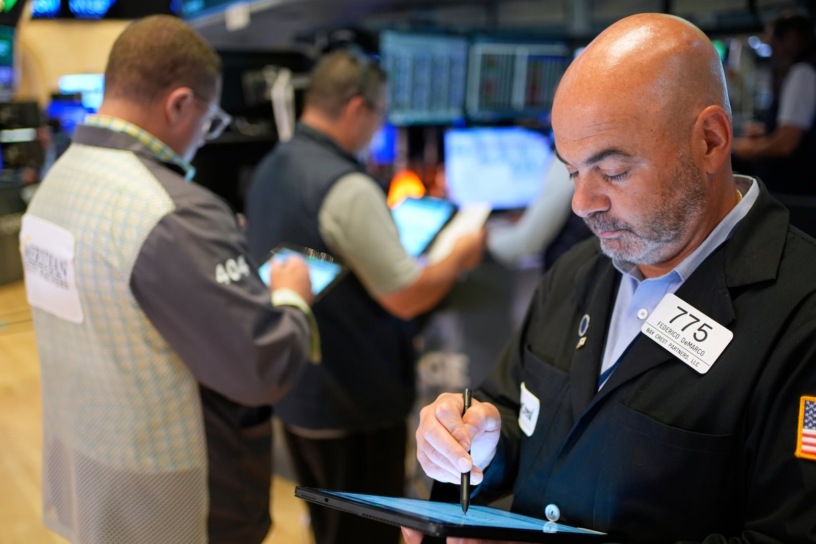 Fredrico DeMarco works on the floor at the New York Stock Exchange in New York, Monday, July 14, 2025. (AP Photo/Seth Wenig)