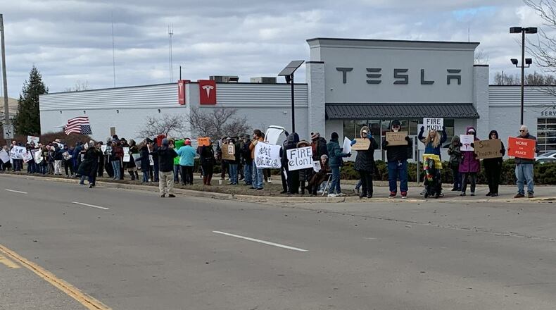 Hundreds of people lined West Dorothy Lane in Moraine on Saturday, March 1, 2025 to protest near a Tesla Service Center. The protest was aimed at Elon Musk, the world's richest man, and his actions with the Trump administration and the Department of Government Efficiency. BROOKE SPURLOCK/STAFF