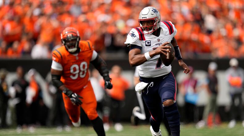 New England Patriots quarterback Jacoby Brissett (7) scrambles up field ahead of Cincinnati Bengals defensive tackle Sheldon Rankins (98) during the first half of an NFL football game, Sunday, Sept. 8, 2024, in Cincinnati. (AP Photo/Carolyn Kaster)