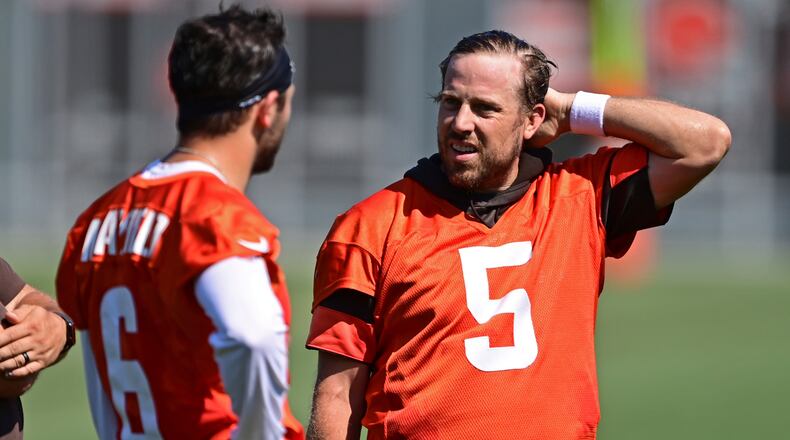 Cleveland Browns quarterback Case Keenum (5) talks with Baker Mayfield during an NFL football practice in Berea, Ohio, Tuesday, Aug. 24, 2021. (AP Photo/David Dermer)