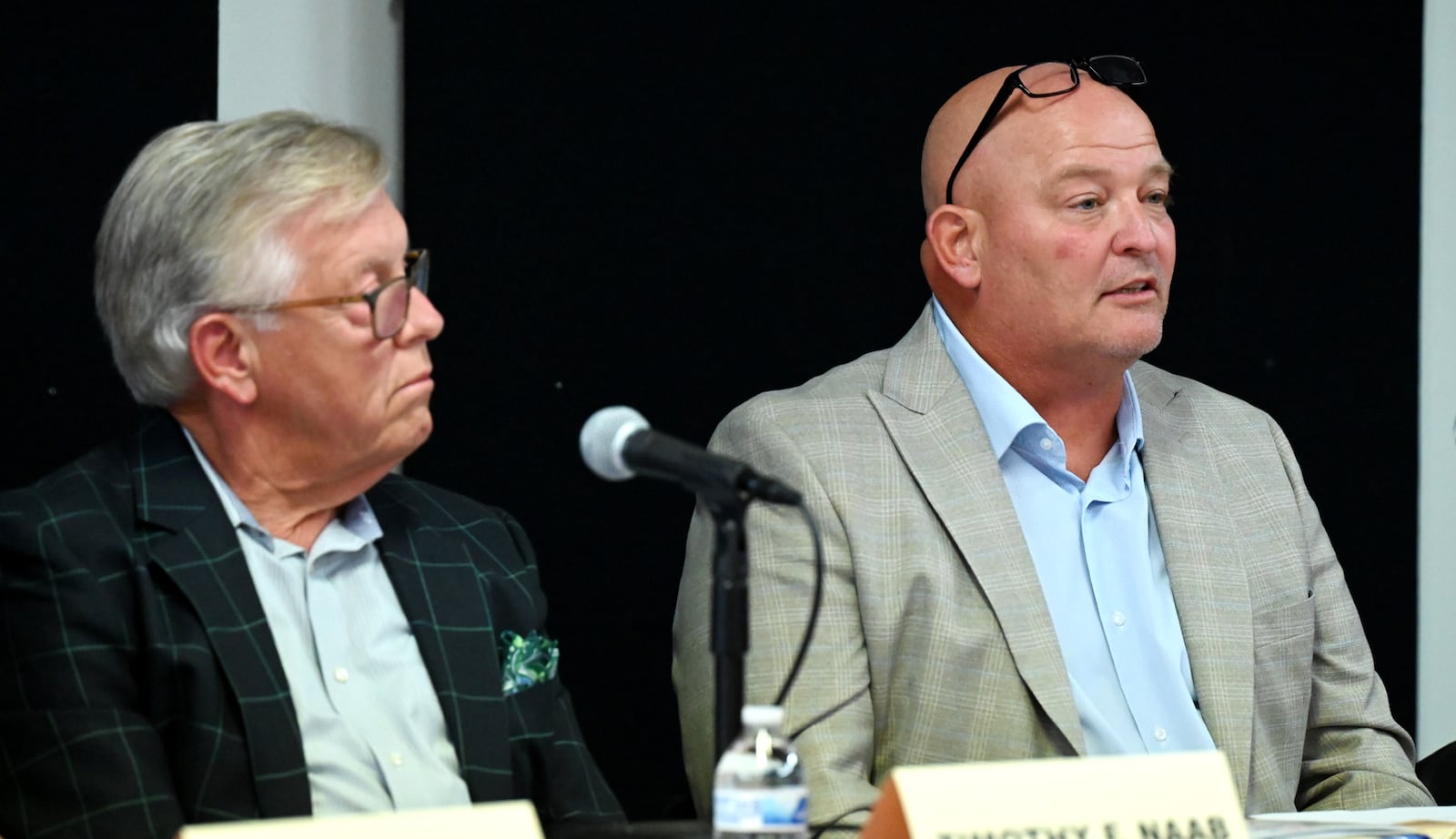 Five people are seeking three open seats on Hamilton City Council in the Nov. 4, 2025, general election. Pictured is incumbent Councilman Joel Lauer (right) answering a question during a Sept. 24, 2025, candidates' forum hosted by the Greater Chamber of Commerce at Miami Downtown Hamilton Center on High Street. Also pictured is incumbent Councilman Tim Naab listening. MICHAEL D. PITMAN/STAFF