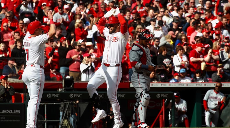 Nick Martini, of the Reds, celebrates with Spencer Steer after hitting a home run in the second inning against the Nationals on Opening Day on Thursday, March 28, 2024, at Great American Ball Park in Cincinnati. David Jablonski/Staff
