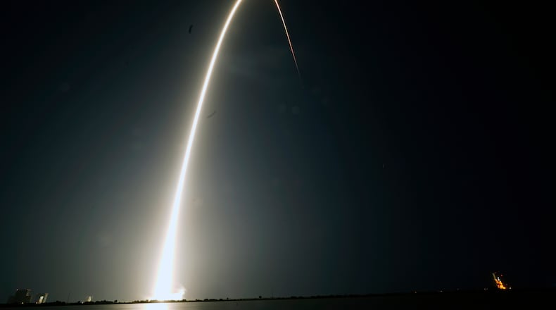 FILE - In this time-exposure photograph, a SpaceX Falcon 9 rocket with the 25th batch of approximately 60 satellites for SpaceX's Starlink broadband network lifts off from the Space Launch Complex 40 at the Cape Canaveral Space Force Station in Cape Canaveral, Fla., late Wednesday, April 28, 2021. (AP Photo/John Raoux, File)