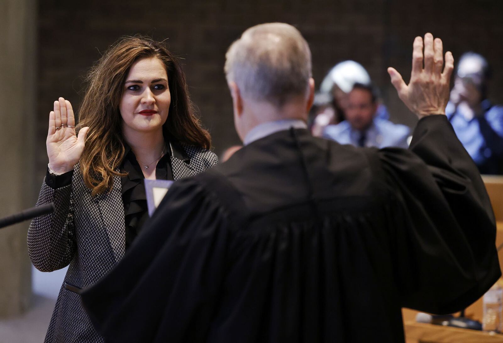 Middletown Municipal Court Judge James Sherron swears in Ashley Combs as Middletown's city manager during Tuesday night's city council meeting. Combs said she's "humbled and honored" to hold the highest position in the city where she has worked nine years. NICK GRAHAM/STAFF