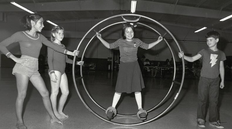 Mini circus members 13-year-old Janelle Russo and 11-year-old Beth Hurst with 10-year-old Tammy Spicer on German Wheel and 10-year-old Todd Jones. JOURNAL-NEWS PHOTO ARCHIVES