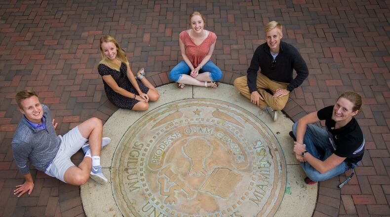 The Ridge siblings gather around Miami University’s famous seal on the Oxford campus of the school. The five are a rarity at Miami, with all of them taking undergraduate or graduate classes from the Butler County university. CONTRIBUTED