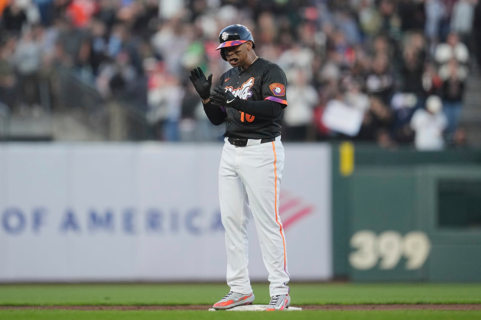 San Francisco Giants' Rafael Devers reacts after hitting an RBI double against the Cleveland Guardians during the third inning of a baseball game in San Francisco, Tuesday, June 17, 2025. (AP Photo/Jeff Chiu)