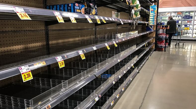 These pasta shelves were empty at the new Kroger Marketplace on Alex Bell . JIM NOELKER/STAFF