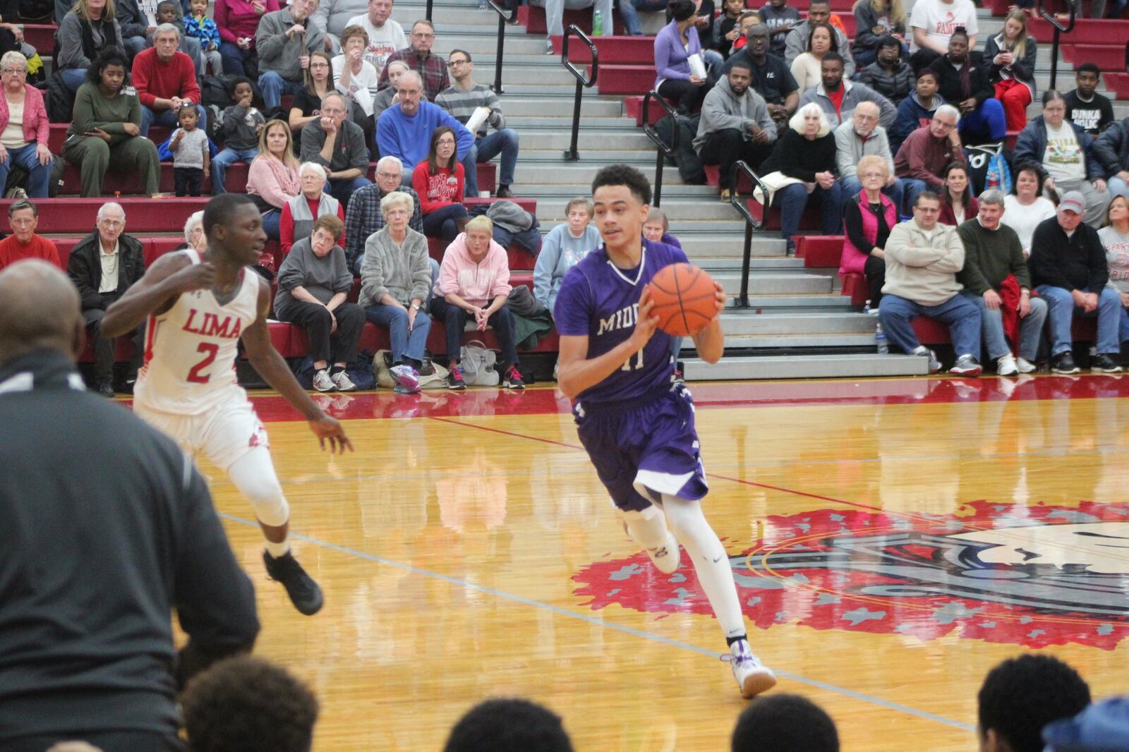 Cliff Snow of Middletown tries to drive around Jarius Ward of Lima Senior during Friday night’s game in Lima. CONTRIBUTED PHOTO BY MARITZA MCKINNEY