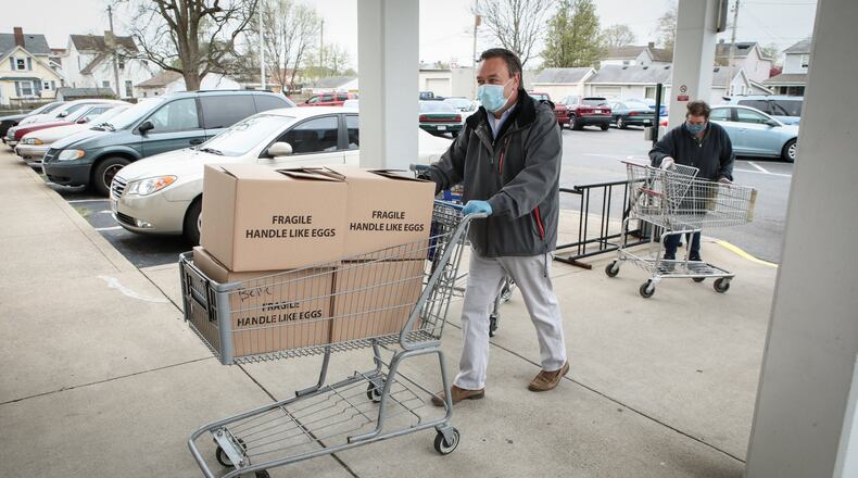 Council on Aging of Southwestern Ohio staff and volunteers deliver LaRosa s meals and personal care supplies to seniors at Belle Tower and Sherman Manor in Hamilton Friday, April 17, 2020. COA serves approximately 26,000 individuals annually, including 5,900 who reside in Butler County. CONTRIBUTED