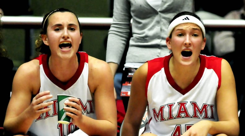 Miami’s Courtney Osborn (left) and Kirsten Olowinski shout encouragement from the bench during the RedHawks’ 84-71 loss to visiting Kentucky on Nov. 14, 2010. JOURNAL-NEWS FILE PHOTO