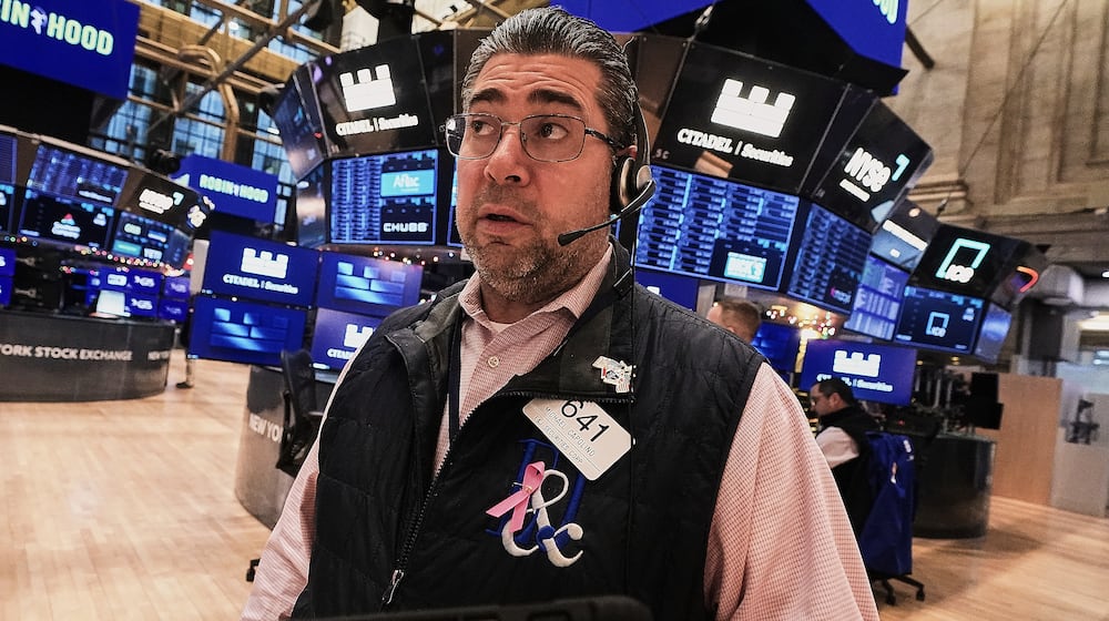 Trader Michael Capolino works on the floor of the New York Stock Exchange, Friday, Jan. 2, 2026. (AP Photo/Richard Drew)