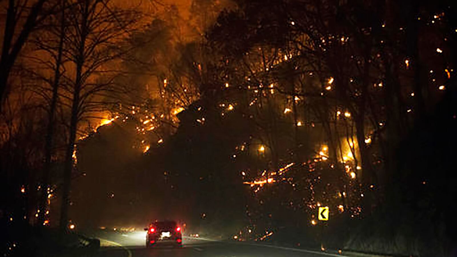 Fire erupts on both side of Highway 441 between Gatlinburg and Pigeon Forge, Tenn., Monday, Nov. 28, 2016. In Gatlinburg, smoke and fire caused the mandatory evacuation of downtown and surrounding areas, according to the Tennessee Emergency Management Agency. (Jessica Tezak/Knoxville News Sentinel via AP)