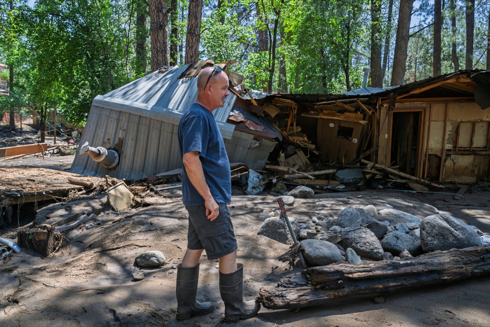 Dan Privett stands on what would be the front of his house, Wednesday, July 9, 2025, in Ruidoso, N.M., which was destroyed in the flash floods yesterday that hit the town. (AP Photo/Roberto E. Rosales)