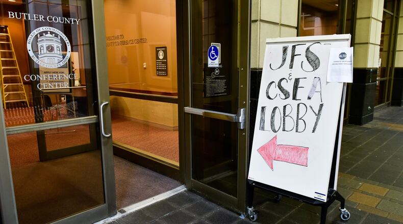 Butler County Job and Family Services and Child Support Enforcement Agency have set up a makeshift office in a conference room on the ground floor of the Government Services Center in Hamilton to help ease access for those in need of help during the coronavirus (COVID-19) outbreak. They are sanitizing tables, keyboards, telephones, pens and other items frequently to help minimize risk of spreading germs. NICK GRAHAM/STAFF