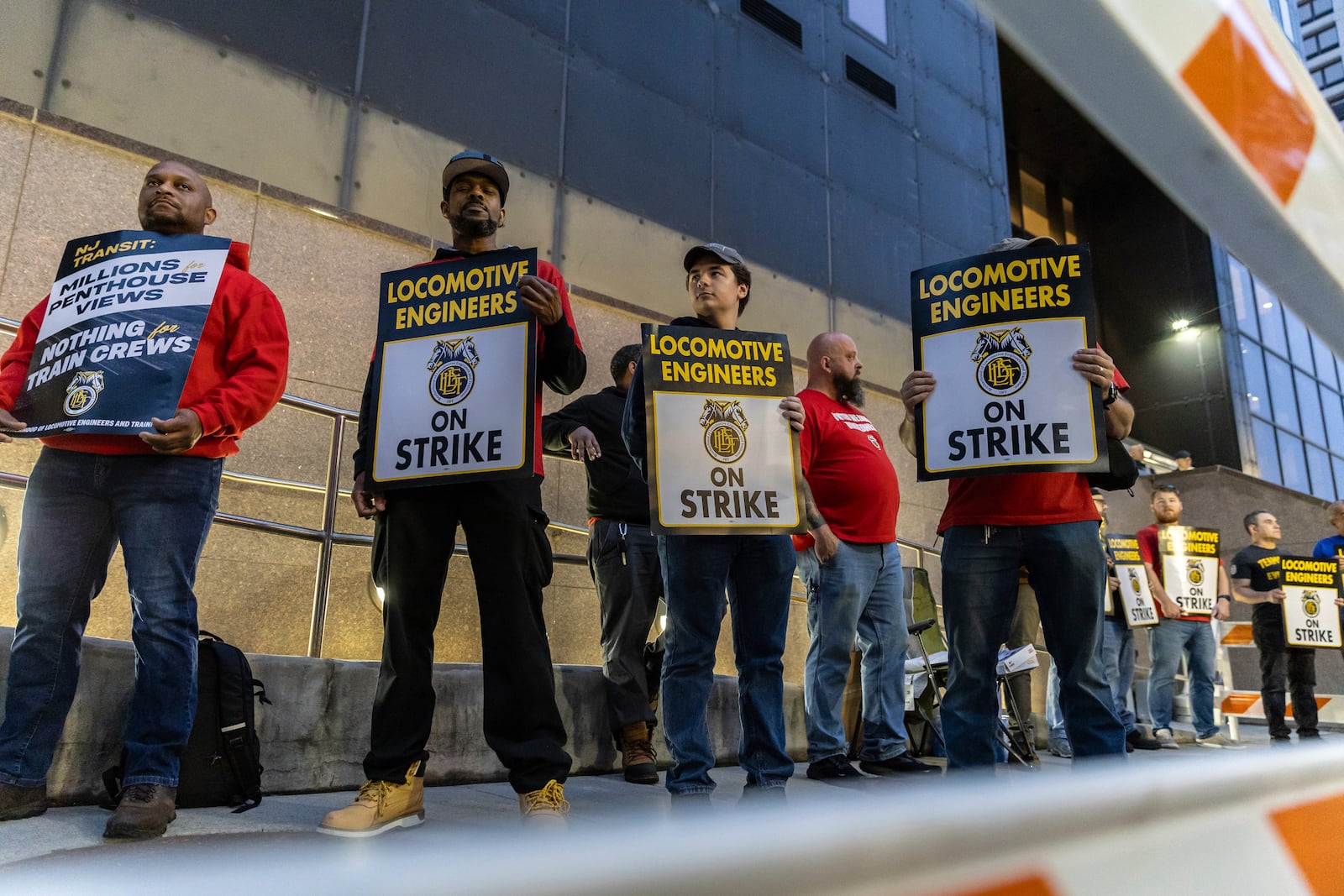 Union members from the Brotherhood of Locomotive Engineers and Trainmen form a picket line outside the NJ Transit Headquarters on Friday, May 16, 2025 in Newark, New Jersey. (AP Photo/Stefan Jeremiah)
