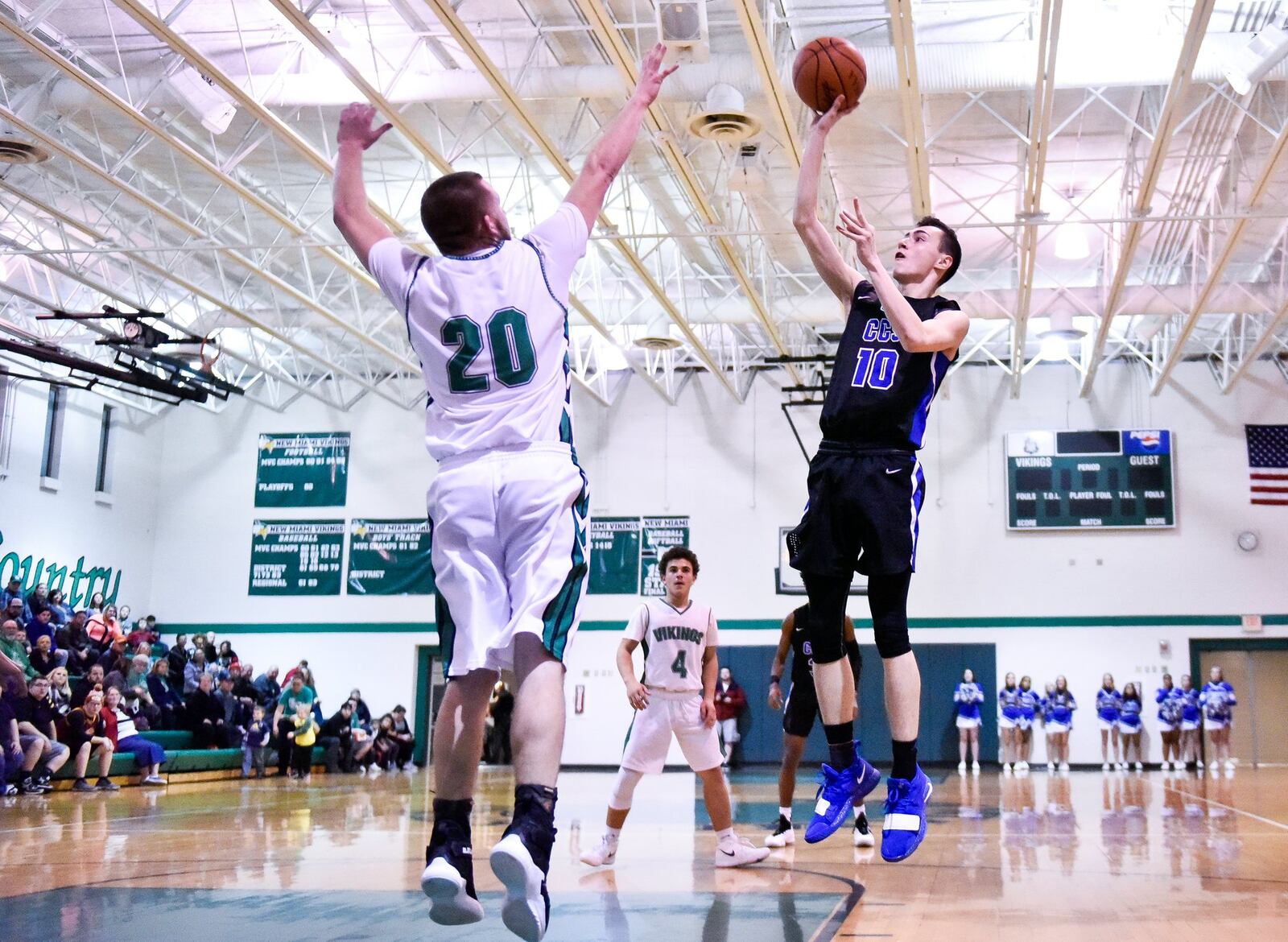 Cincinnati Christian’s Cole Martin puts up a shot defended by New Miami’s Ronnie Bowman during their game Dec. 14, 2018, at New Miami. CCS won 70-52. NICK GRAHAM/STAFF