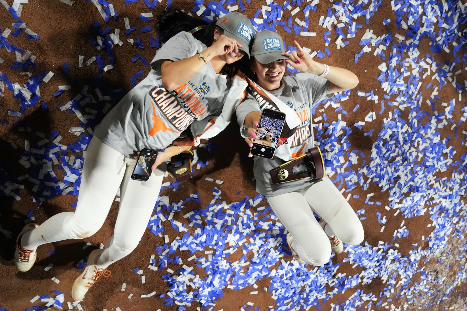 Texas' Shylien Brister, left, and Vanessa Quiroga celebrate after winning the Women's College World Series softball championship against Texas Tech in Oklahoma City, Friday, June 6, 2025. (AP Photo/Kyle Phillips)