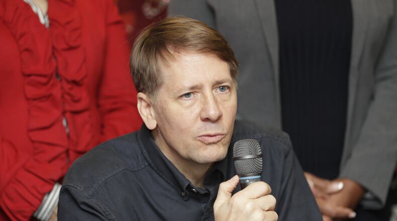 Richard Cordray speaks during a news conference, Wednesday, Jan. 10, 2018, in Akron, Ohio. (AP Photo/Tony Dejak)