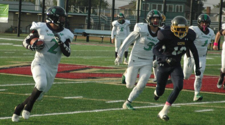 New Miami’s David Cunningham (2) turns the corner on Cincinnati College Prep Academy’s Zaire Mobley (12) on Saturday at Western Hills’ McCartney Stadium. New Miami won 36-8. RICK CASSANO/STAFF