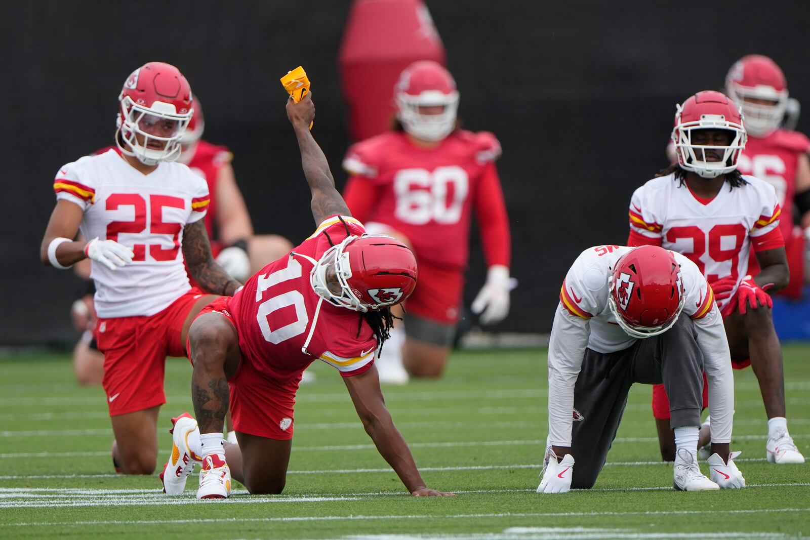 Kansas City Chiefs running back Isiah Pacheco (10) stretches with teammates during the NFL football team's practice Tuesday, June 17, 2025, in Kansas City, Mo. (AP Photo/Charlie Riedel)