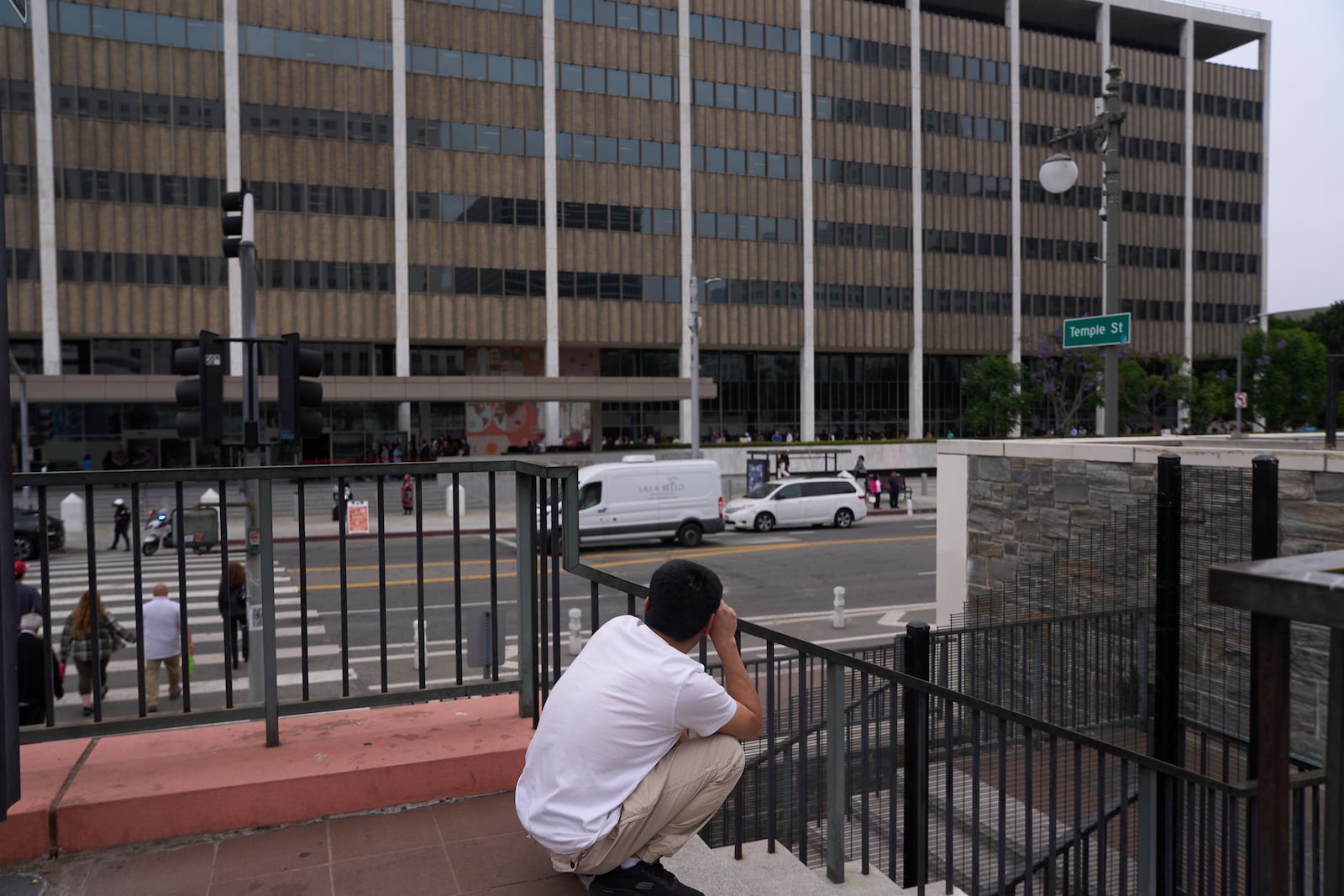 People line up outside the Los Angeles Federal Building in Los Angeles, housing the U.S. Immigration and Customs Enforcement (ICE) and U.S. Citizenship and Immigration Services (USCIS) on Wednesday, June 25, 2025. (AP Photo/Damian Dovarganes)