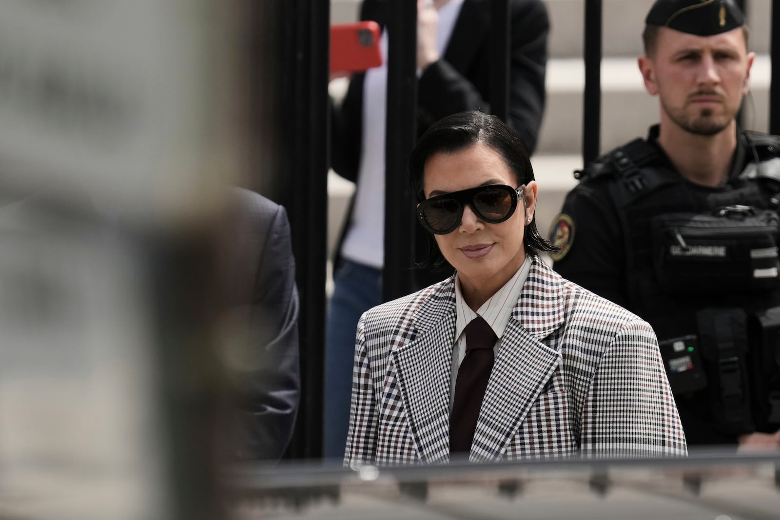 Kris Jenner, center, the mother of Kim Kardashian, arrives for a trial regarding a robbery of millions of dollars in jewels from Kim Kardashian's Paris hotel room in 2016, in Paris, Tuesday, May 13, 2025. (AP Photo/Aurelien Morissard)