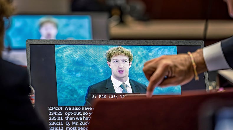 Lawyers for the plaintiff watch on a laptop as a recording of Meta Founder and CEO Mark Zuckerberg's deposition is played for the jurors on Wednesday, March 4, 2026, in Santa Fe, N.M. (Jim Weber/Santa Fe New Mexican via AP, Pool)