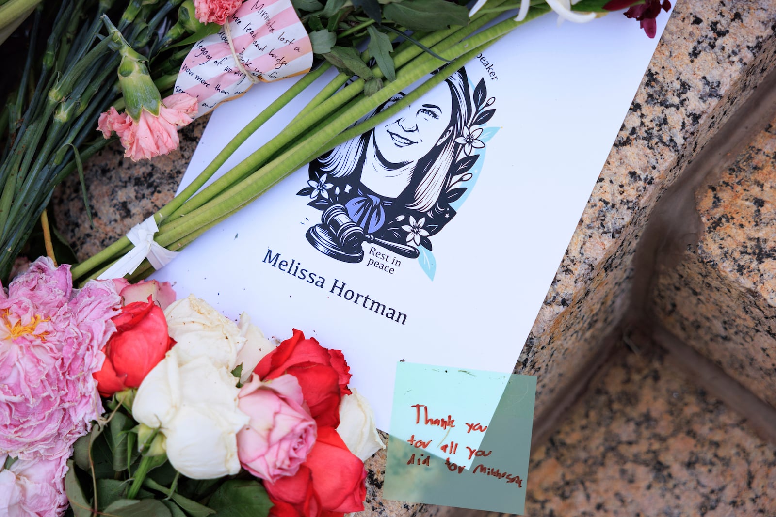 People attend a candlelight vigil for former House Speaker Melissa Hortman and her husband Mark, who were fatally shot, at the state Capitol, Wednesday, June 18, 2025, in St. Paul, Minn. (AP Photo/Nikolas Liepins)