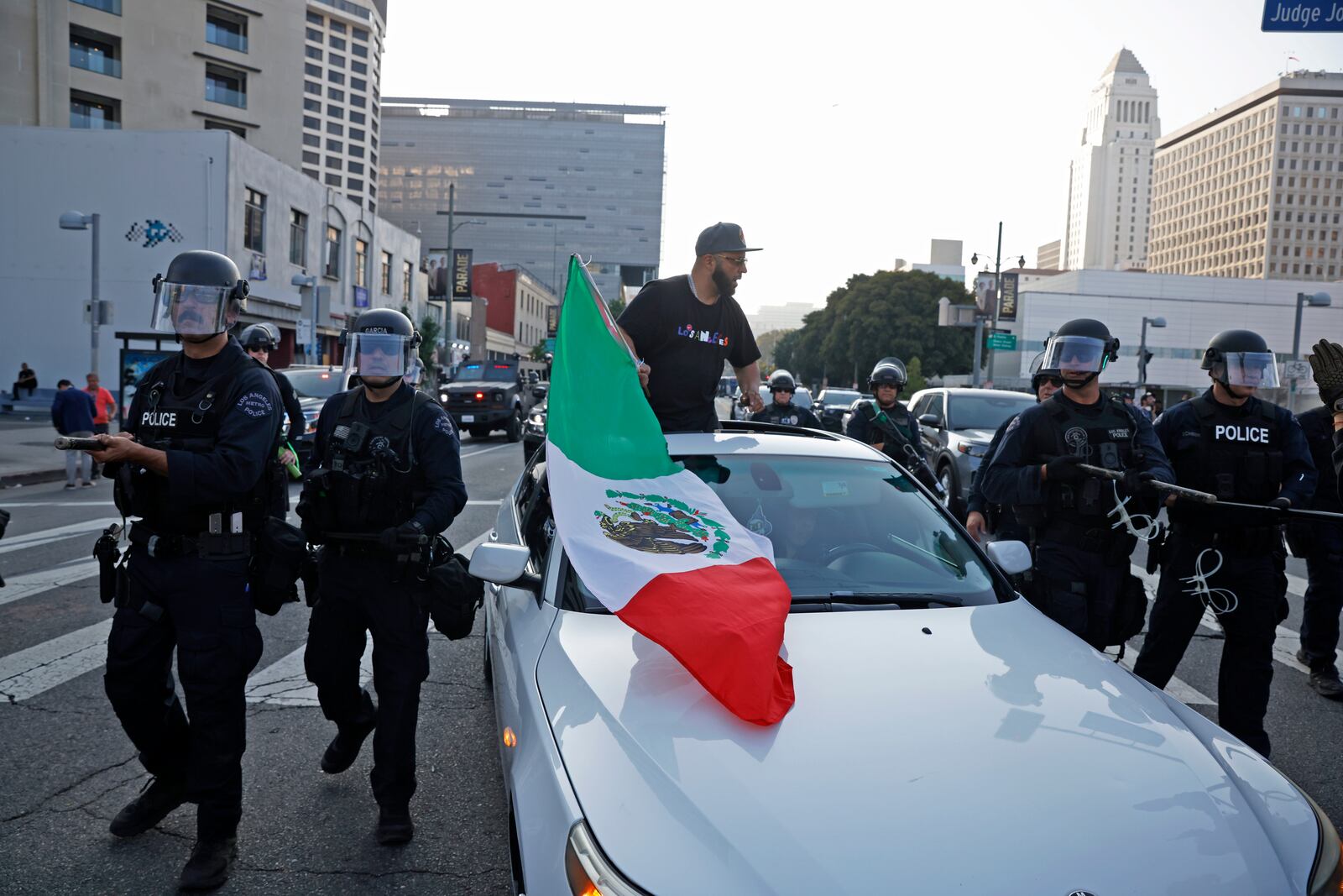 Protesters rally during a protest in response to a series of United States Immigration and Customs Enforcement (ICE) raids, in Los Angeles, on Monday, June 9, 2025. (Stephen Lam/San Francisco Chronicle via AP)