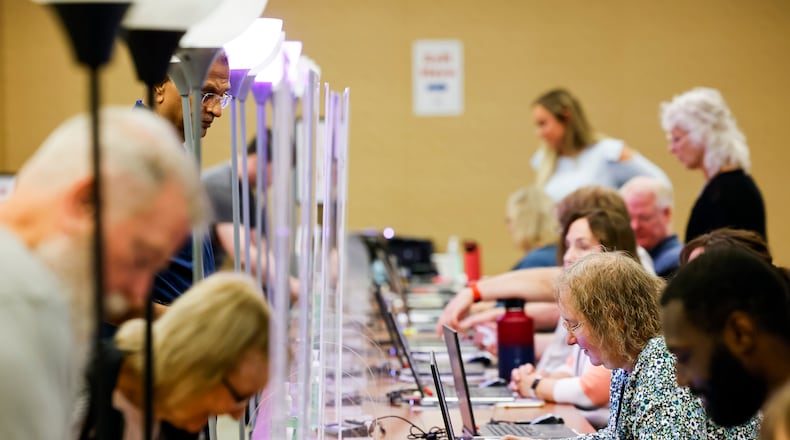 Poll workers are seen during early voting at the Butler County Board of Elections in October 2022. For the Special Election on Aug. 8, Butler County needs more than 100 more poll workers. NICK GRAHAM/FILE
