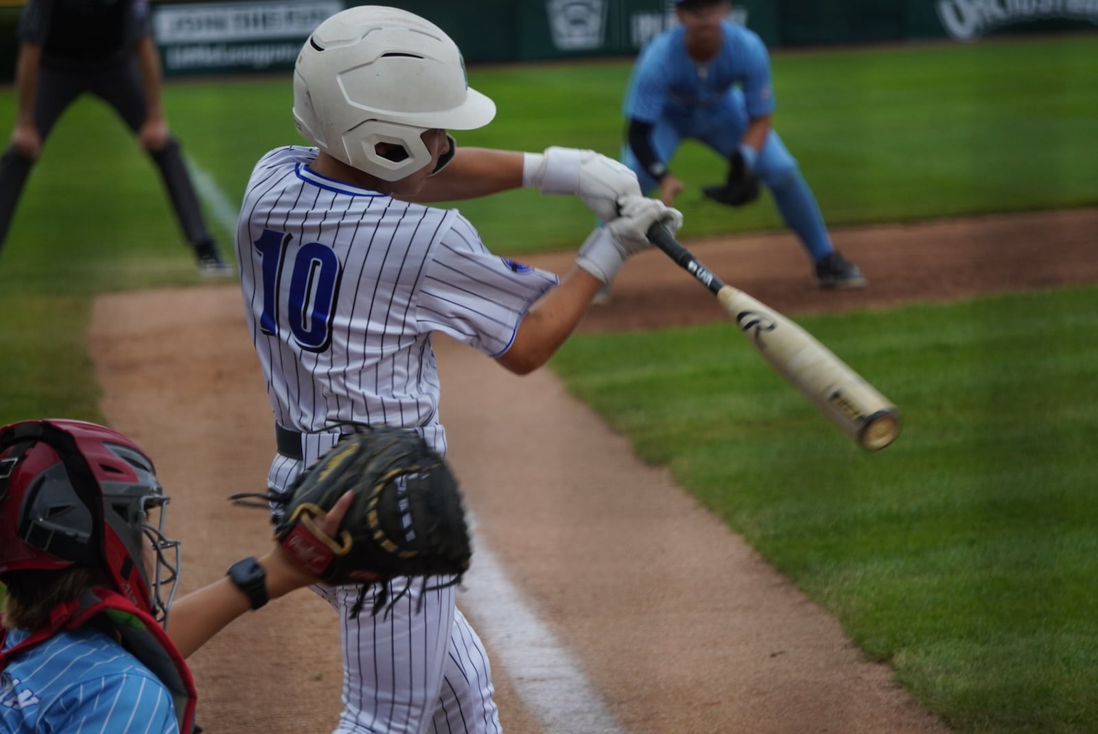 West Side Little League's Boone Treadway takes a swing during his Great Lakes Region winner's bracket semifinal game against Illinois on Monday at the Little League Central Region Complex in Whitestown, Indiana. West Side won 11-1 in four innings. CHRIS VOGT / CONTRIBUTED