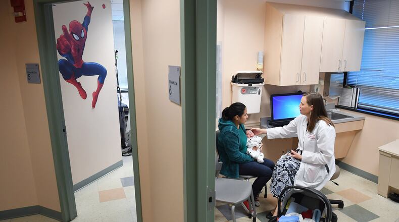 Ana Elsy Ramirez Diaz holds her son, Milan Rojas Ramirez, as he is seen by physician Margaret-Anne Fernandez at the Inova Cares Clinic for Children in Falls Church, Virginia. A portion of the clinic’s patients are insured through the Children’s Health Insurance Program. MUST CREDIT: Washington Post photo by Matt McClain