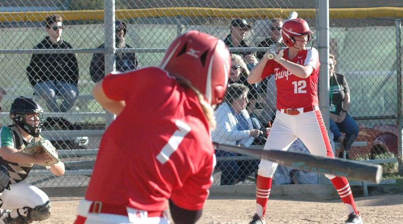 Fairfield High School's Maiah Hodge (1) takes a warmup swing while teammate Lindsey Mitchell (12) stands in at the plate Tuesday, April 9, during a nonconference softball game at Harrison. The host Wildcats won 2-1. RICK CASSANO/STAFF