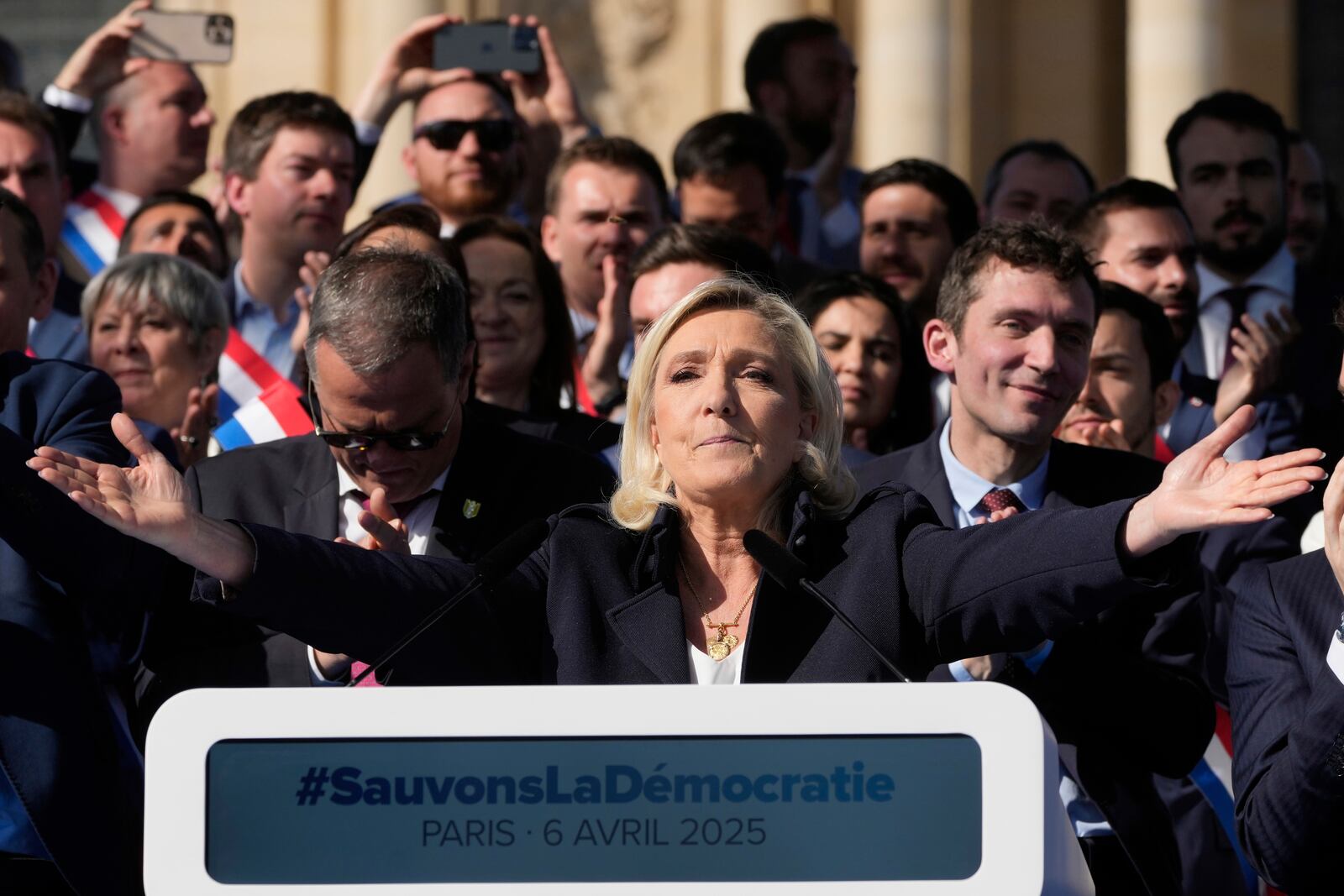 French far-right leader Marine Le Pen delivers her speech during the French far-right party national rally near the parliament in Paris, Sunday, April 6, 2025. (AP Photo/Michel Euler)