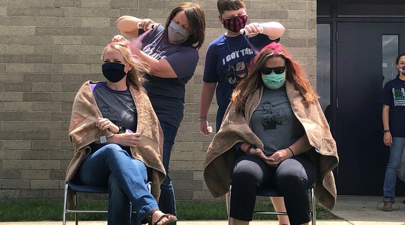 Talawanda Middle School students rallied recently through a hair-dyeing fundraiser to help a teacher who learned she had breast cancer just before Christmas. Students and staffers donated money - nearly $1,300 - to have their hair dyed pink in honor of the international color of breast cancer awareness. (Provided Photo\Journal-News)