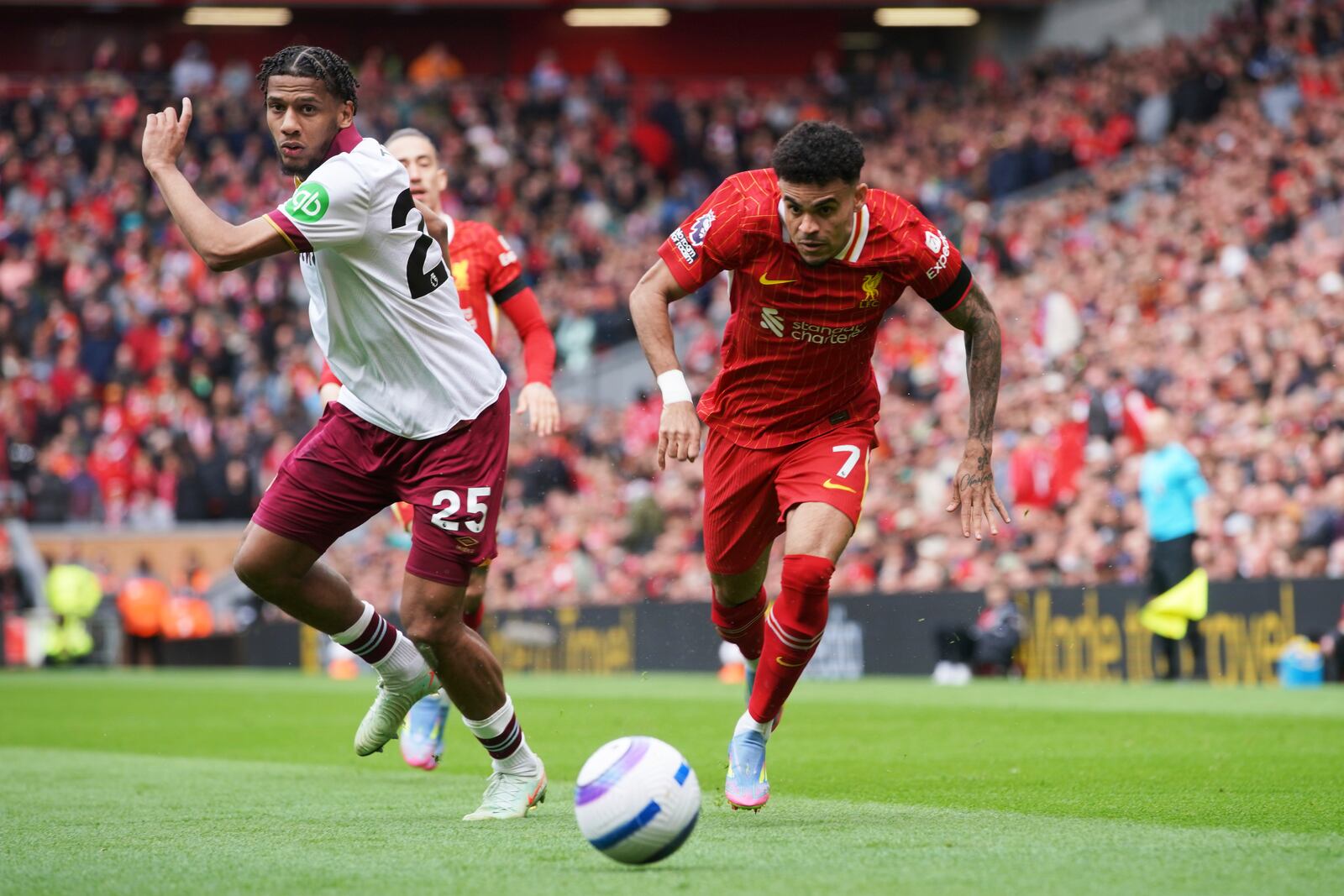 Liverpool's Luis Diaz, right, in action against West Ham's Jean-Clair Todibo during the English Premier League soccer match between Liverpool and West Ham United at Anfield in Liverpool, Sunday, April 13, 2025. (AP Photo/Ian Hodgson)