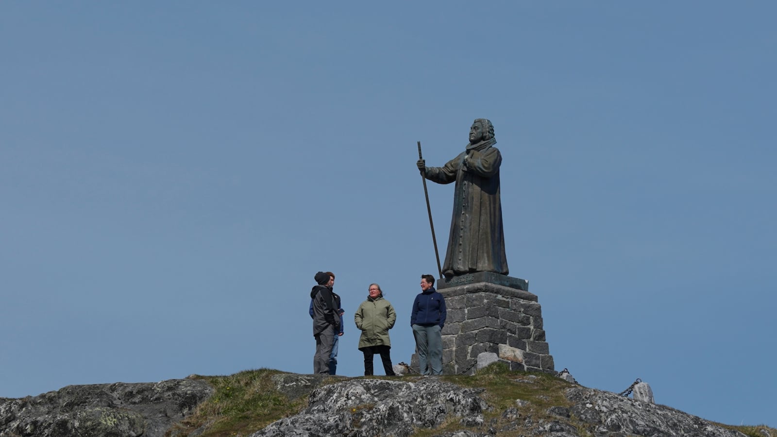 Tourists stand in front of the Statue of Hans Egede in Nuuk, Greenland, Sunday, June 22, 2025. (AP Photo/Kwiyeon Ha)