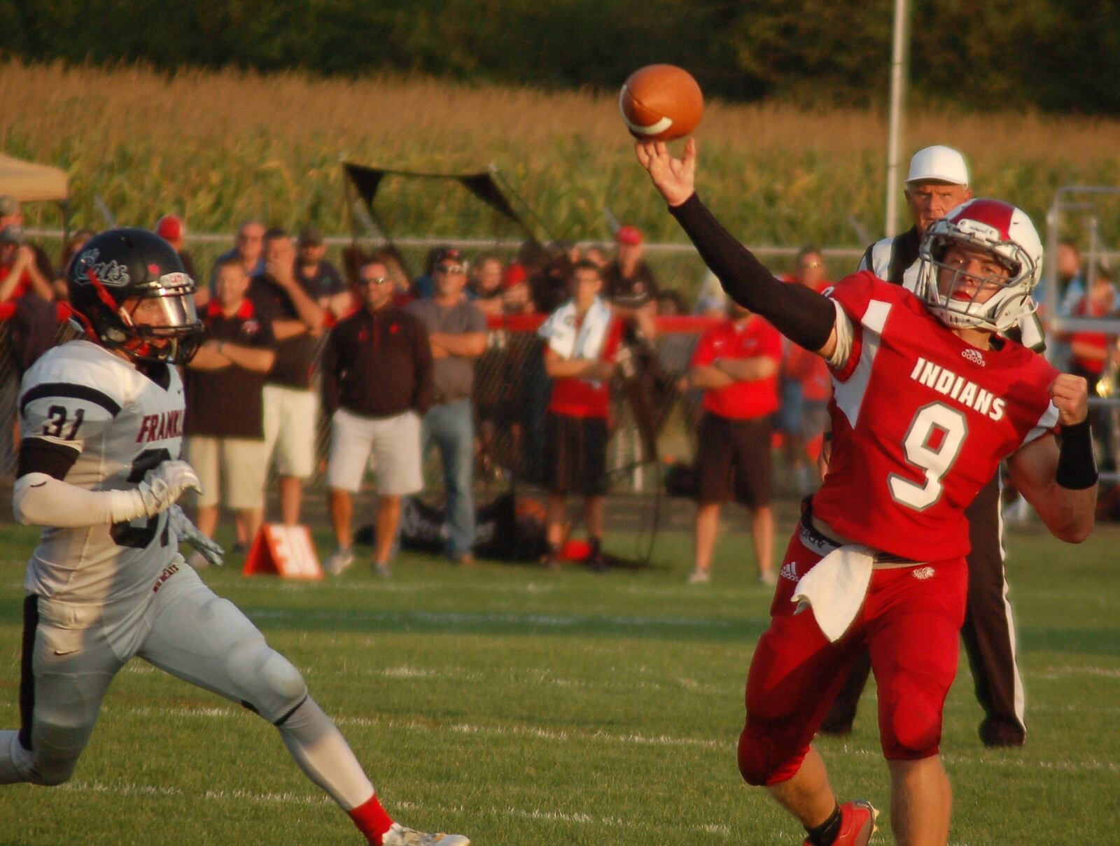 Carlisle quarterback Jake Moore delivers a pass as Franklin’s Carson Bowling pursues Aug. 25 at Laughlin Field in Carlisle. The host Indians dropped a 47-14 decision. CONTRIBUTED PHOTO BY JOHN CUMMINGS