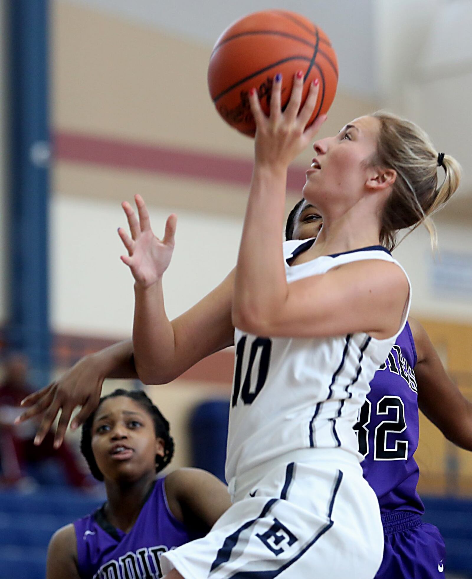 Edgewood’s Lauren Gerber gets a shot off between Middletown’s Olivia Wells-Daniels (left) and Monique Prather (32) on Saturday during the inaugural All-Butler County All-Star girls basketball game at the Hamilton Athletic Center. CONTRIBUTED PHOTO BY E.L. HUBBARD