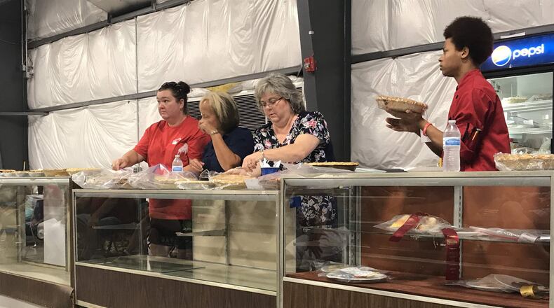 The three judges of today’s pie tasting begin their work cutting into some cherry pies. PATRICK KECK / STAFF
