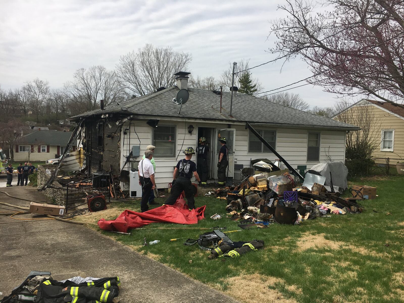 After an attic fire in the 1200 block of Southern Hills Boulevard was put out Wednesday morning, Hamilton firefighters tossed ruined items in the back yard. RICK McCRABB/STAFF